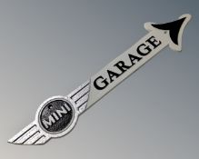 A cast iron Mini garage arrow plaque.