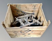 A vintage wooden crate containing wool winders.