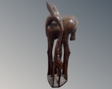 An African hardwood carving of a deer and fawn.