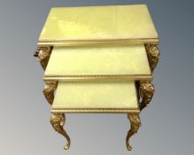 A nest of three gilt and onyx tables.