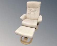A contemporary swivel relaxer armchair with stool upholstered in cream leather.