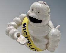 A cast iron novelty Michelin Man money box.