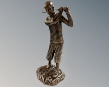 A cast iron figure of a golfer in bronzed finish