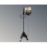A 20th century wrought iron rise and fall standard lamp.