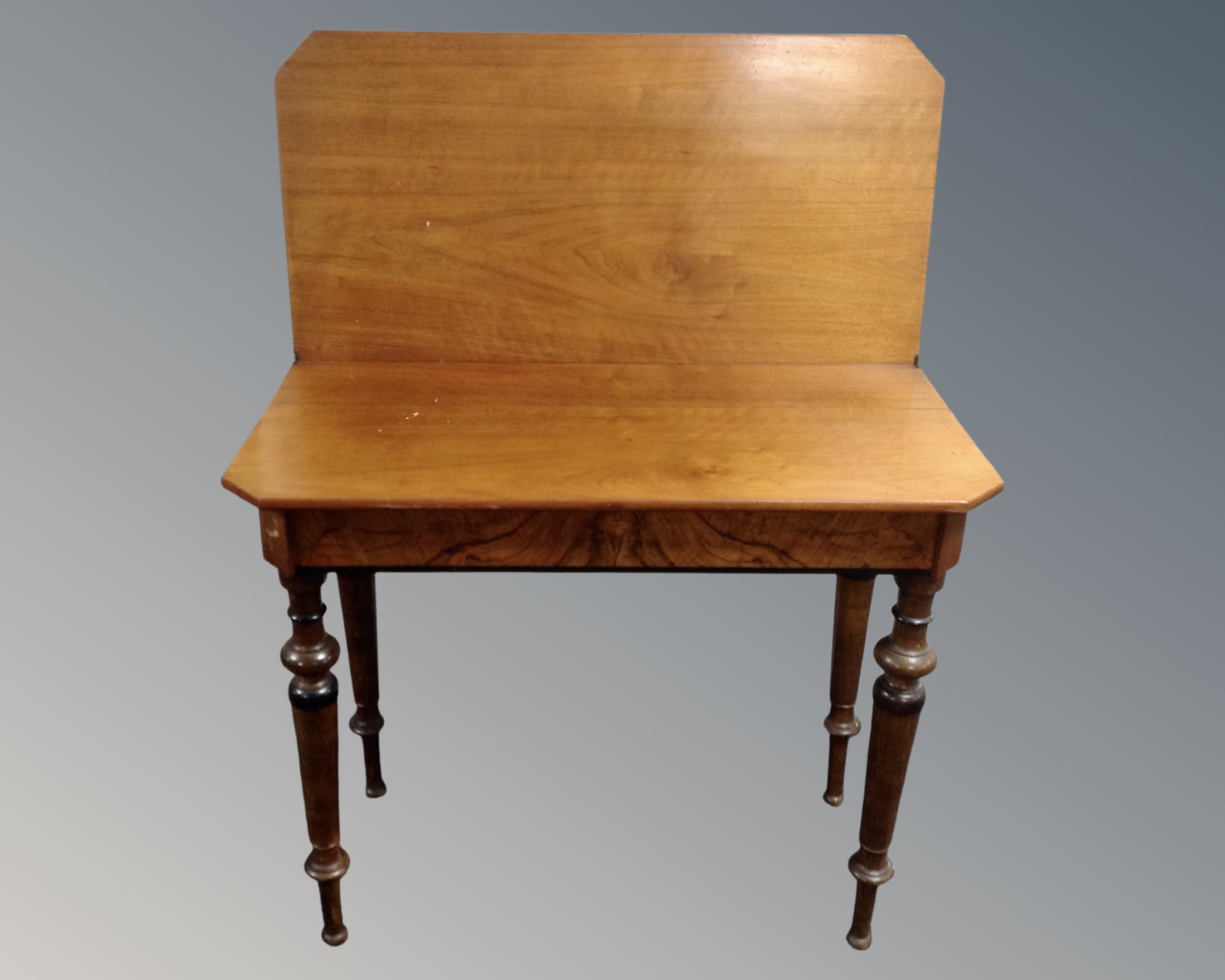 A 19th century mahogany and walnut turnover top tea table.