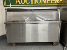A stainless steel food warming counter.