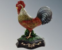 A cast iron cockerel doorstop.