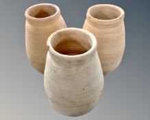 Three terracotta plant pots.
