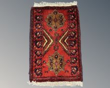 A small eastern hearth rug, 42cm by 63cm.