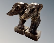 A pair of cast iron greyhound head figures.
