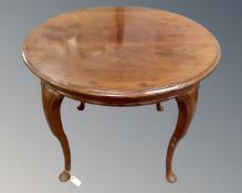 An early 20th century circular mahogany occasional table on cabriole legs.