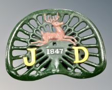 A cast iron John Deere tractor seat.