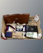 A box containing Freemason's leather bags, aprons, a silver medal,