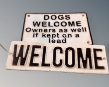 Two cast iron wall plaques, Welcome and Dogs Welcome.