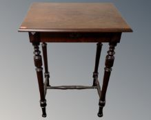 An early 20th century mahogany work table on raised legs.