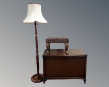 A 20th century oak panelled blanket box together with a footstool and a standard lamp with shade.