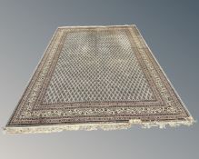 A machined Indian carpet on blue ground, 350cm by 255cm.