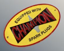 A cast iron Champion spark plugs wall plaque.