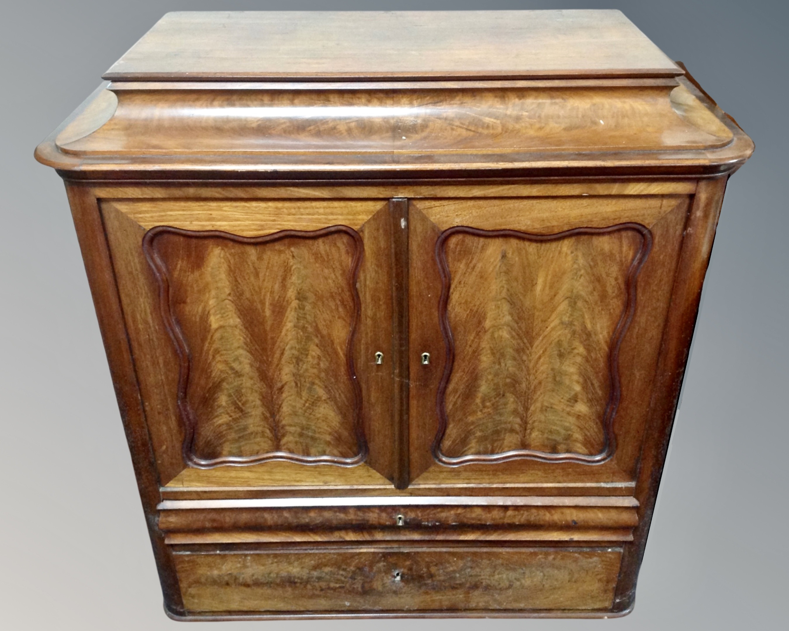 A 19th century continental mahogany double door cocktail cabinet fitted with two drawers beneath.