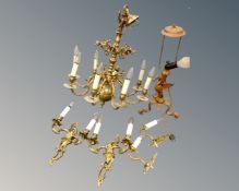 A continental brass eight way light fitting together with a further gilt metal table lamp and two