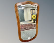 A continental inlaid mahogany shield shaped mirror, 47cm by 84cm.