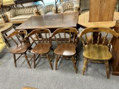 A set of four stained beech elbow chairs.