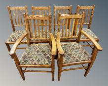 A set of six oak rail back chairs comprising of two carvers and four singles.