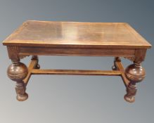 A 20th century rectangular oak dining table on bulbous legs.