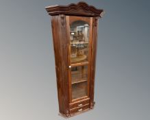 A stained pine glazed door corner display cabinet fitted with two drawers beneath and porcelain