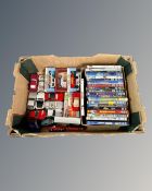 A box containing children's DVDs, boxed and unboxed die cast vehicles including Simba and Matchbox.