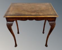 An inlaid occasional table on cabriole legs.