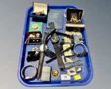 A tray containing Casio and Sekonda wristwatches, assorted coinage, gold plated cuff links,