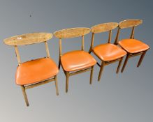 A set of four mid-20th century Danish teak dining chairs.