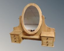 A stripped pine dressing table mirror fitted with three drawers.