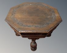 A heavily carved octagonal oak occasional table on bulbous legs.