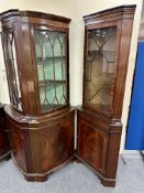 Two corner display cabinets fitted with cupboards beneath in a mahogany finish.