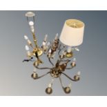 A continental brass eight way light fitting together with a further six way light fitting and three