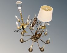 A continental brass eight way light fitting together with a further six way light fitting and three