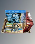 A box containing Lord of the Rings chess set together with a glass three-in-one chess set and a