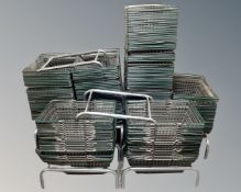 A large quantity of wire metal shopping baskets together with seven stands, three on castors.