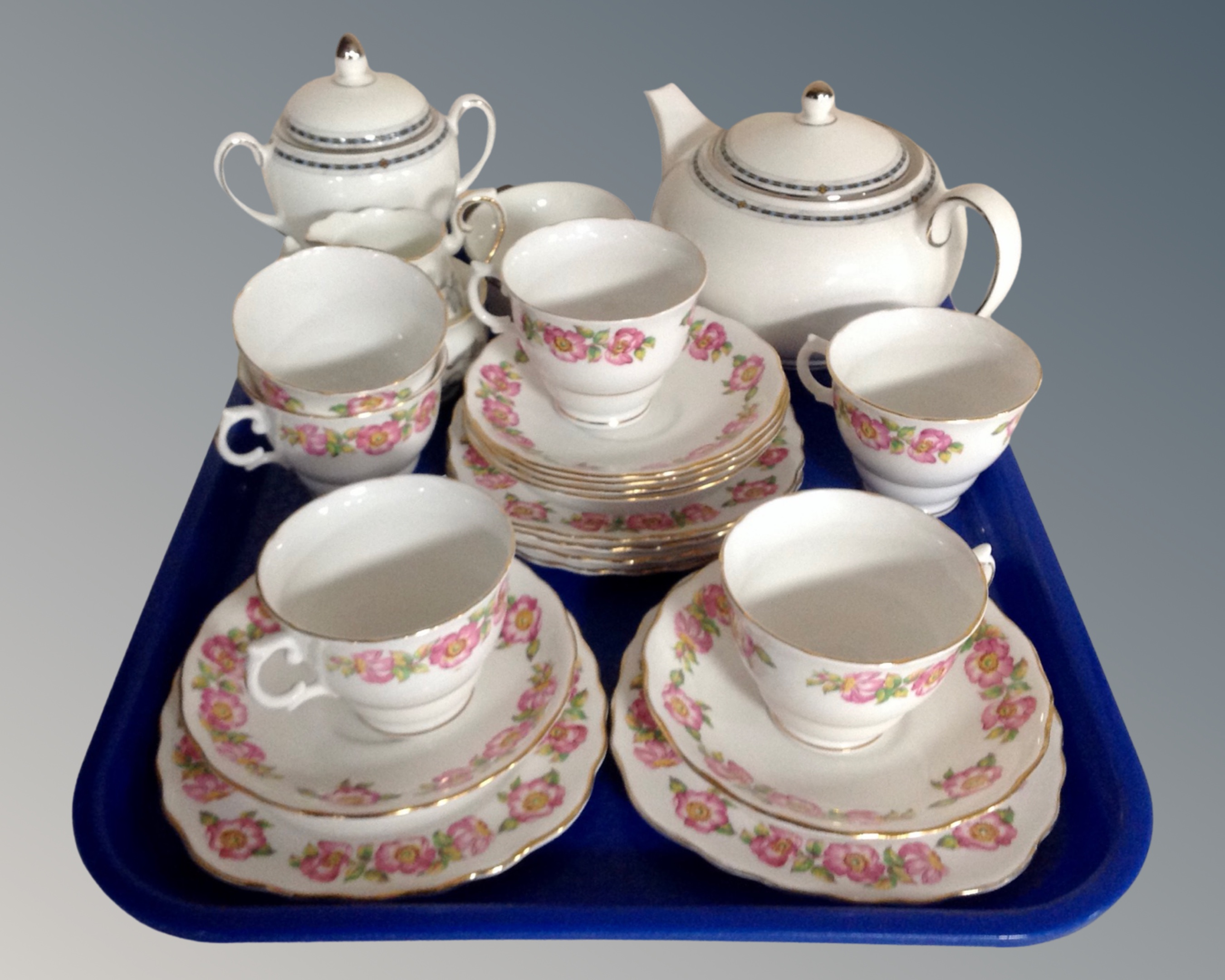 Six English pink rose patterned bone china trios together with a Wedgwood Contrasts teapot,