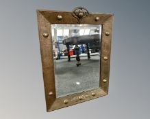 An Arts and Crafts brass framed mirror 65 cm x 49 cm.