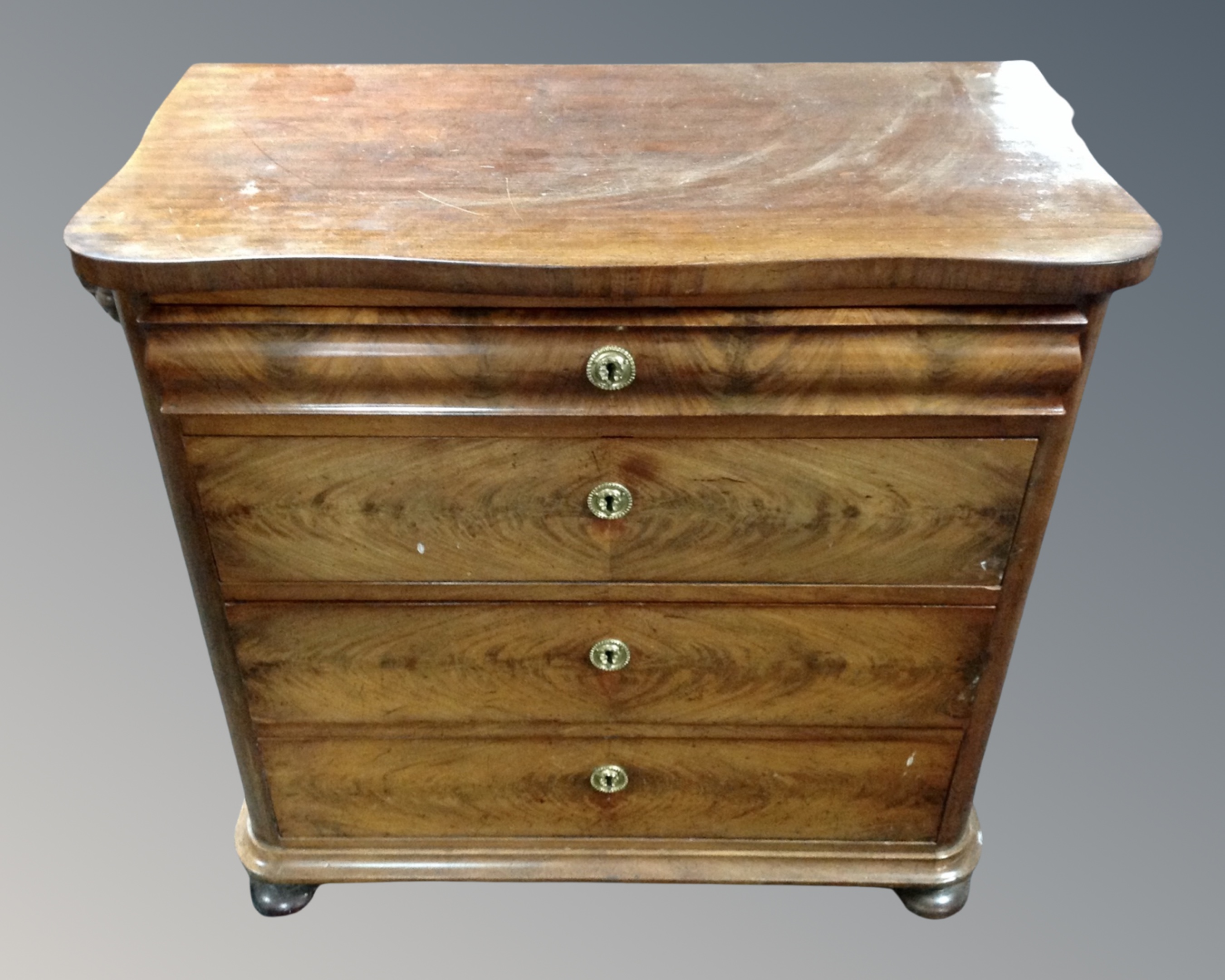 A 19th century mahogany serpentine fronted four drawer chest.