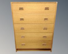 A mid-20th century Scandinavian five drawer chest in an oak finish.