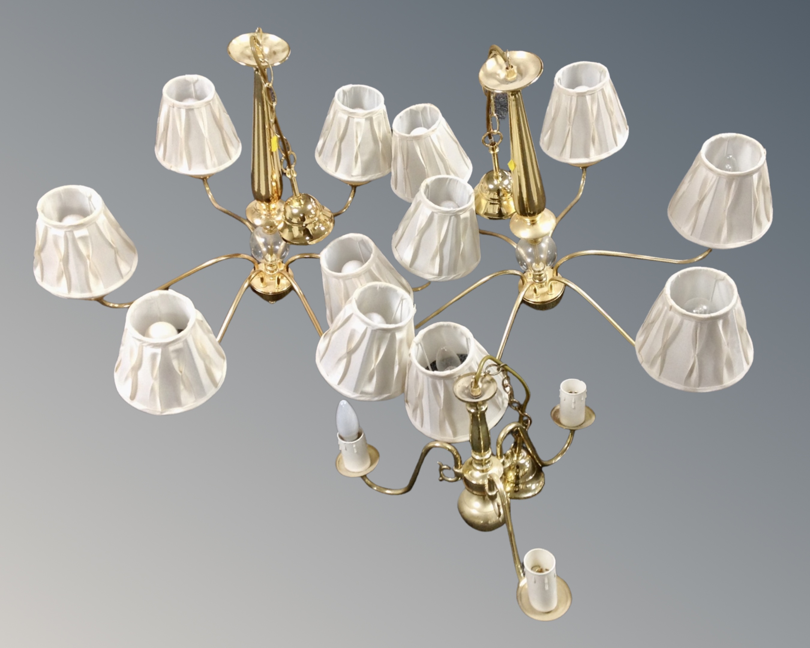 A pair of contemporary brass six way light fittings, with shades,