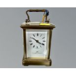 A Swiss-made 11 jewel brass cased carriage clock with key, retailed by Matthew Norman.
