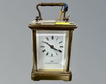 A Swiss-made 11 jewel brass cased carriage clock with key, retailed by Matthew Norman.