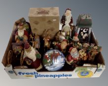 A box containing assorted Christmas ornaments including Heartwood Creek wooden figures.