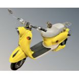 A Chinese-made Italian-style electric scooter, yellow, not yet registered as a motor vehicle,