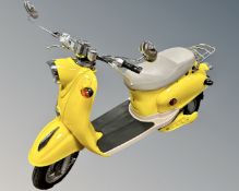 A Chinese-made Italian-style electric scooter, yellow, not yet registered as a motor vehicle,